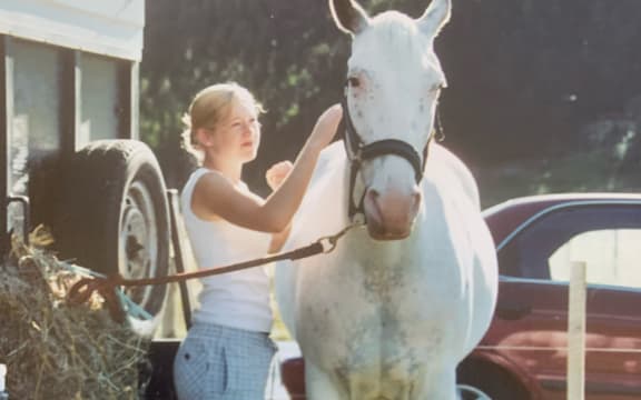 Sarah dresses a white horse