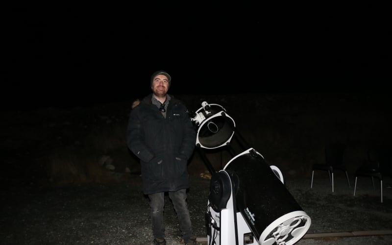 Tour guide and business manager Sam Blair with a Dobsonian telescope.