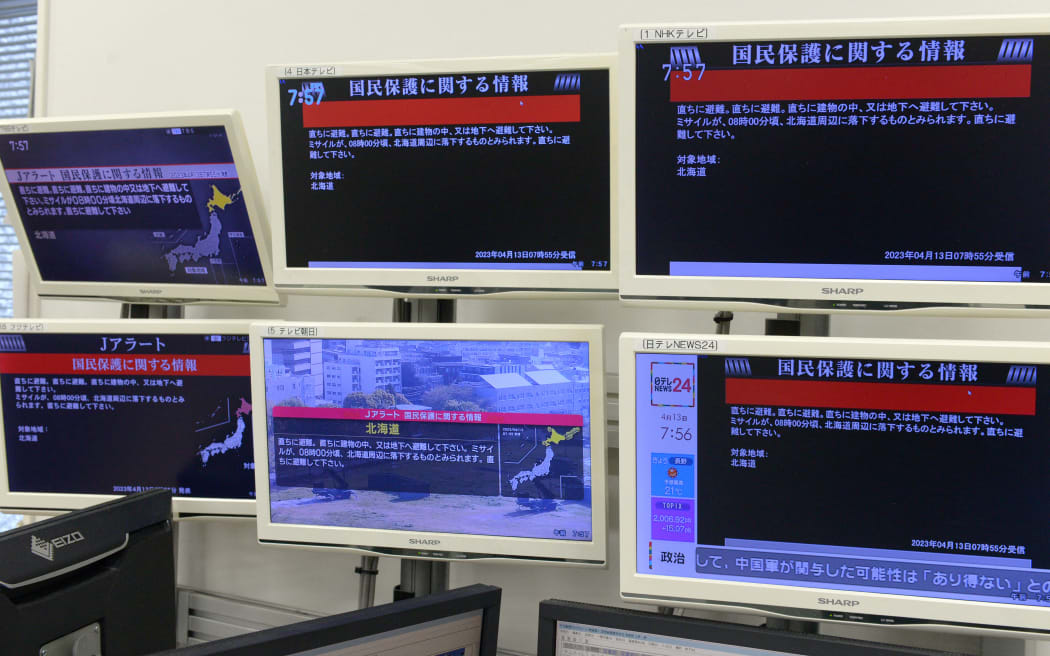 Monitors of TV programs shows the J-ALERT, the early warning system used in Japan, in Tokyo on April 13, 2023. Japan Government issued an alert to warn Hokkaido residents of North Korea’s missiles falling and said they might be fallen off Hokkaido around afterward.