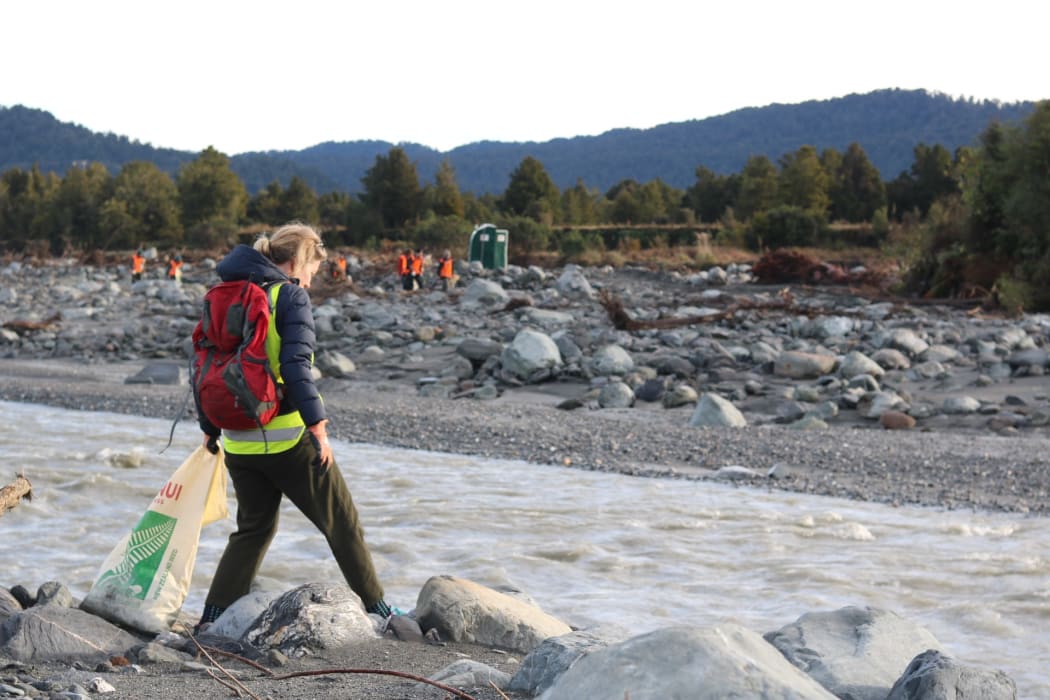 Volunteers pick up rubbish where a disused Fox River landfill spilled litter on the West Coast.
