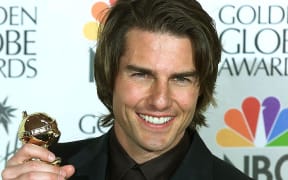 Actor Tom Cruise holds his Golden Globe award for Best Performance by an Actor in a Supporting Role in a Motion Picture Drama for his role in "Magnolia" at the 57th Annual Golden Globe Awards in 2000.