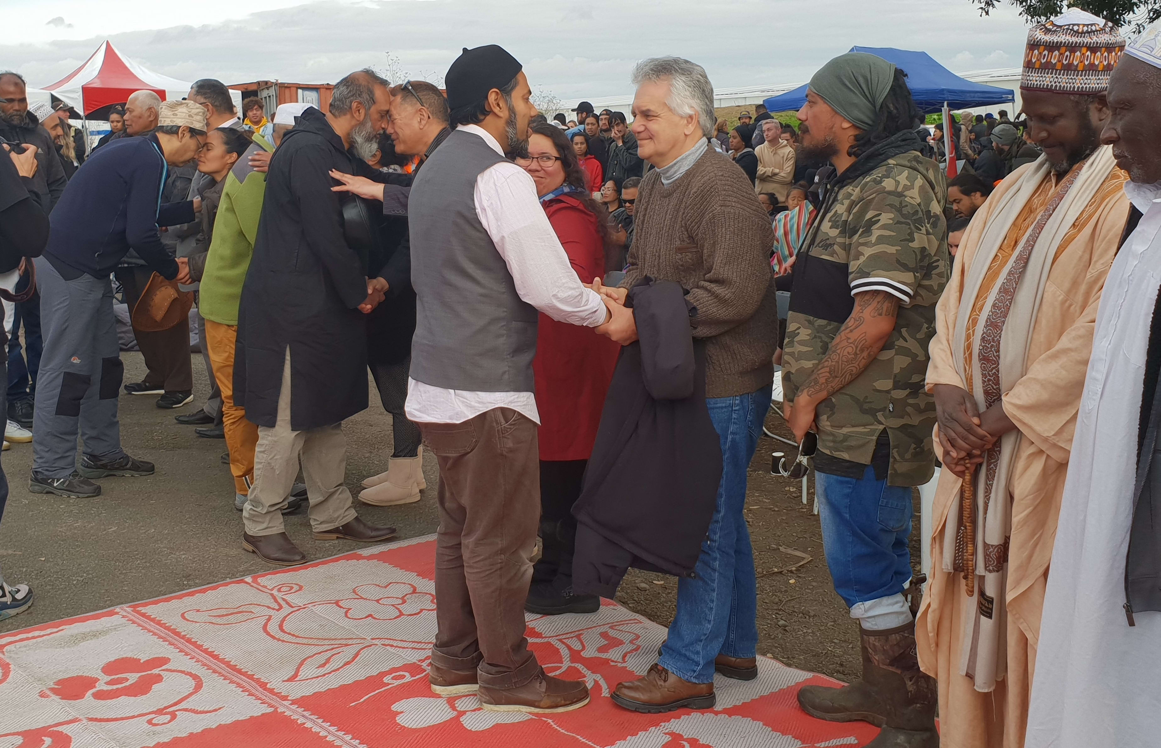 A Muslim leader greets lawyer Moana Jackson at a powhiri at Ihumātao.