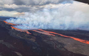 This aerial image released by the US Geological Survey (USGS) from Civil Air Patrol on November 28, 2022, shows the lava on the northeast rift zone of Mauna Loa in Hawaii. - Hawaii's Mauna Loa, the largest active volcano in the world, has erupted for the first time in nearly 40 years, US authorities said, as emergency crews went on alert early Monday. (Photo by Handout / US Geological Survey / AFP) / RESTRICTED TO EDITORIAL USE - MANDATORY CREDIT "AFP PHOTO / US Geological Survey " - NO MARKETING - NO ADVERTISING CAMPAIGNS - DISTRIBUTED AS A SERVICE TO CLIENTS