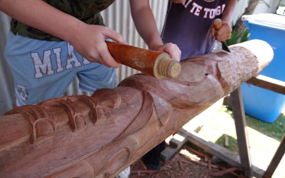 The power pole being carved into a pair of pou was destroyed during Cyclone Gabrielle.