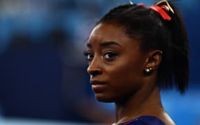 Simone Biles gets ready to compete in the uneven bars event of the  artistic gymnastics women's qualification during the Tokyo 2020 Olympic Games on 25 July 2021.