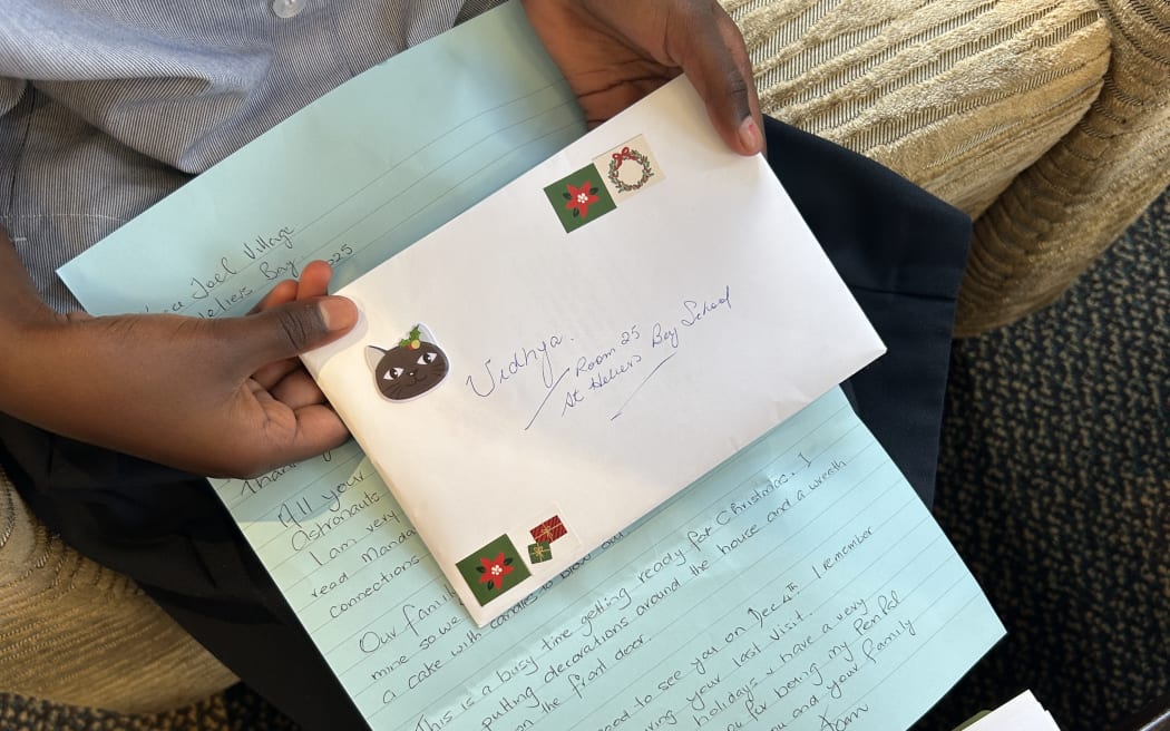 Photo of a letter with cat and Christmas stickers on the envelope.