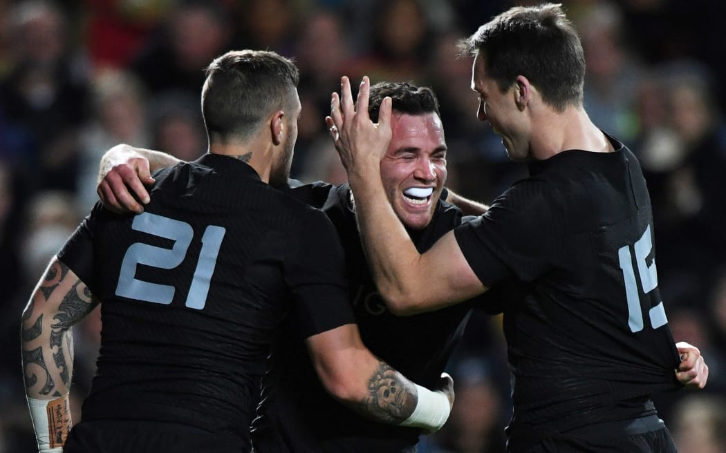 Ryan Crotty celebrates his try with team mates TJ Perenara and Ben Smith.