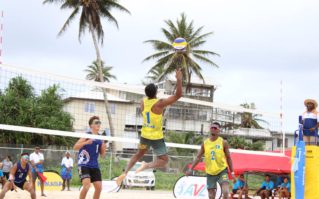 Team Palau (yellow uniforms), the eventual gold medal winner, playing against Northern Mariana Islands in beach volleyball. Photo: Wilmer Joel.