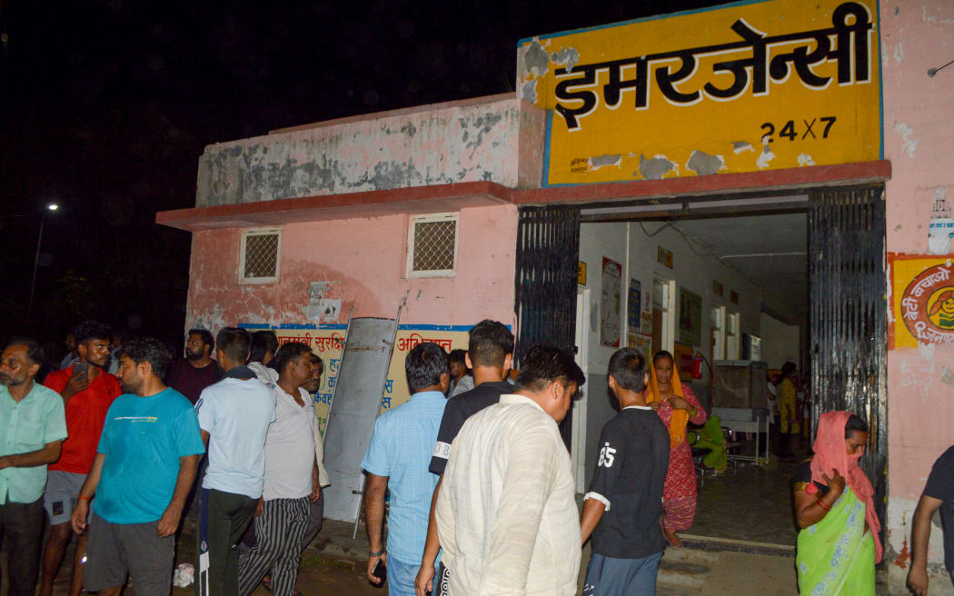 Mourners gather as the deceased who died in a melee during a sermon, are brought to a hospital in Hathras in India's Uttar Pradesh state on July 2, 2024. Nearly 100 people were crushed to death in a stampede at a Hindu religious gathering in northern India on July 2, with many others injured, a senior government official said. (Photo by Pawan SHARMA / AFP)