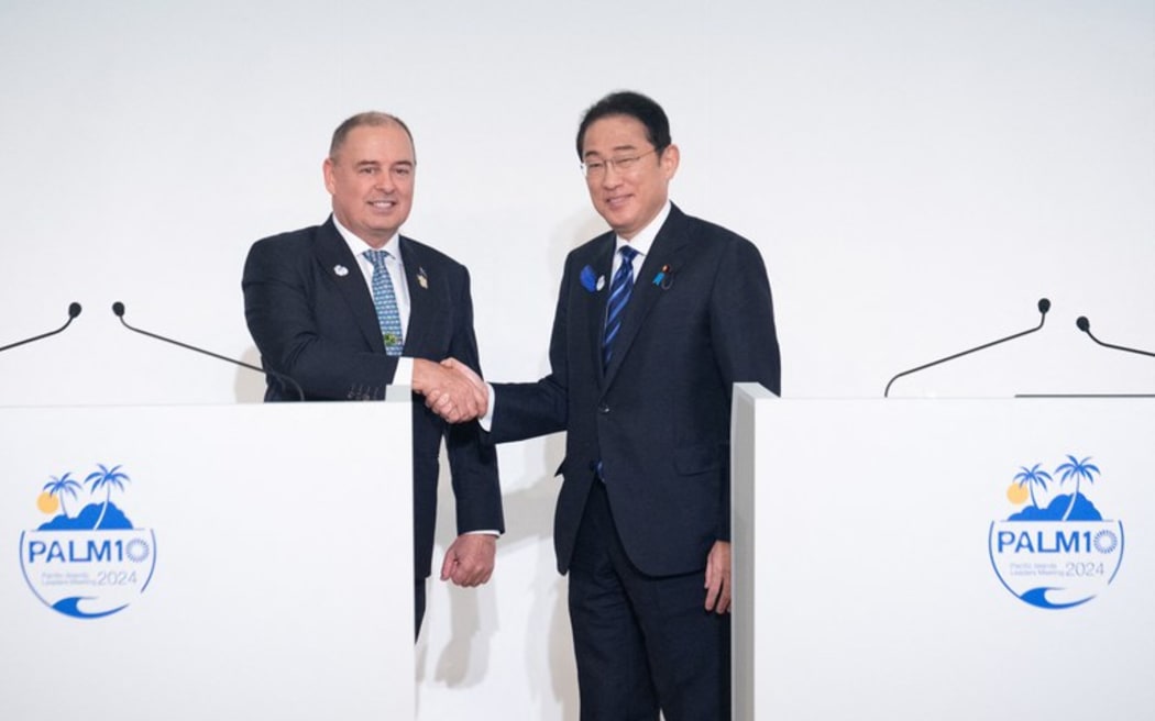 Cook Islands Prime Minister Mark Brown (L) and Japanese Prime Minister Fumio Kishida shake hands during a joint press conference following the 10th Pacific Islands Leaders' Meeting (PALM10) in Tokyo on July 18, 2024. (Yuichi Yamazaki/AFP)
