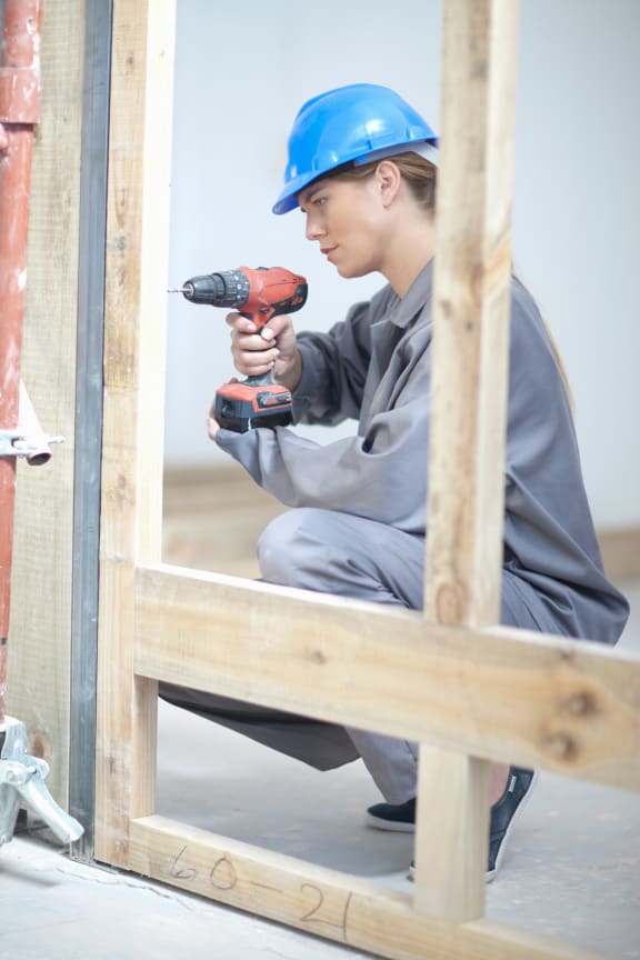 Woman working on construction site.