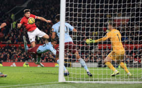 Harry Maguire of Man Utd fires in a header.