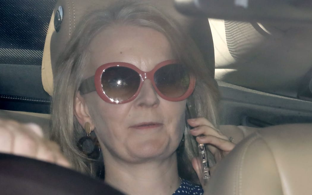 Britain's International Trade Secretary Liz Truss speaks on her phone as she is driven into the Houses of Parliament in central London on September 25, 2019. - British MPs returned to parliament on Wednesday following a momentous Supreme Court ruling that struck down Prime Minister Boris Johnson's decision to suspend the house weeks before the Brexit deadline. (Photo by Tolga AKMEN / AFP)
