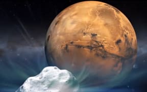 An artist's concept illustration provided by NASA depicts the Comet Siding Spring and Mars.