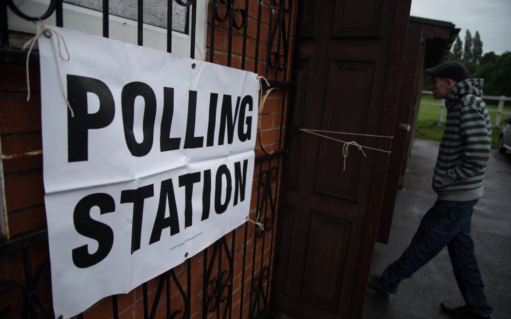 A person arrives at a polling station in Stockport, United Kingdom, in 2017.