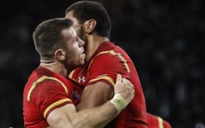 Try scorer Gareth Davies of Wales is congrautulated by Taulupe Faletau.