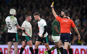 Jack Crowley of Ireland is shown a yellow card by referee Matthew Carley during the Quilter Nations Series 2025 match between Ireland and South Africa at the Aviva Stadium.