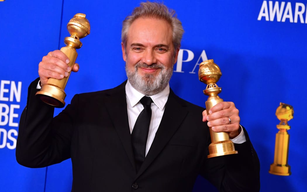 British film director Sam Mendes poses in the press room with the awards for Best Director - Motion Picture and best Best Motion Picture - Drama.