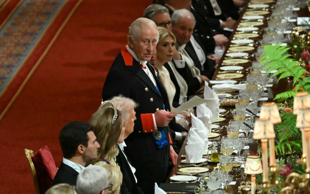 Britain's King Charles III (C) stands to deliver a speech at a State Banquet at Windsor Castle, in Windsor, on September 17, 2025, during the second State Visit of US President Donald Trump.