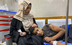 A Palestinian youth who was injured by Israeli fire near a US-backed aid center in the Rafah area, receives treatment at the Nasser hospital in the southern Gaza Strip on 3 June 2025.