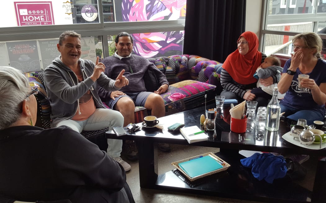 Maori language tutor Bernie Edwards, second left, talks with students at Kapu Kōrero.
