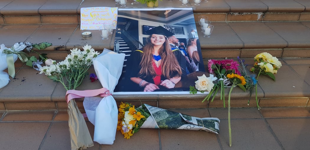 An image of Grace Millane surrounded by flowers at a vigil in Wellington. 12 December 2018