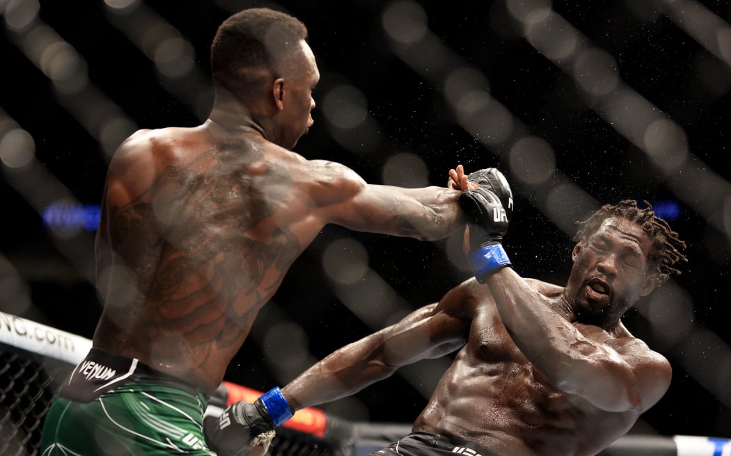 LAS VEGAS, NEVADA - JULY 02: Israel Adesanya (L) of Nigeria punches Jared Cannonier in their middleweight title bout during UFC 276 at T-Mobile Arena on July 02, 2022 in Las Vegas, Nevada.   Carmen Mandato/Getty Images/AFP (Photo by Carmen Mandato / GETTY IMAGES NORTH AMERICA / Getty Images via AFP)