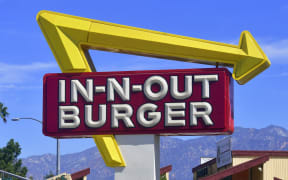The signs points to an In-N-Out Burger restaurant in Alhambra, California on August 30, 2018.