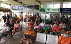People waiting at the airport in Rarotonga on the first day of the travel bubble with New Zealand.