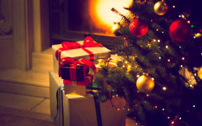 Christmas gifts wrapped under tree.
