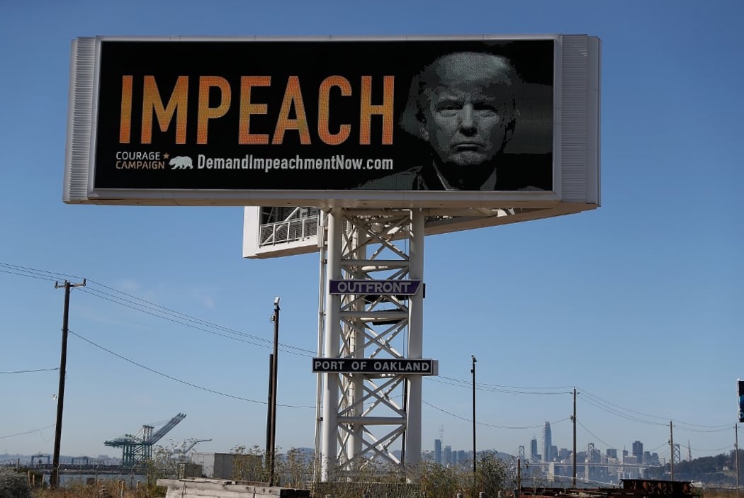 OAKLAND, CA - SEPTEMBER 25: An electronic billboard next to the San Francisco-Oakland Bay Bridge reads "IMPEACH" with an image of U.S. President Donald Trump on September 25, 2017 in Oakland, California.
