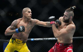 Brazil's Alex Pereira, left, punches Czech Republic's Jiri Prochazka during the second round of a light heavyweight title bout at the UFC 295.