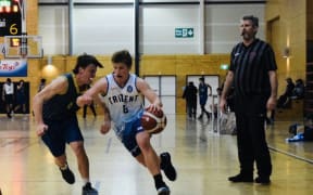 Cy Coldiron (with ball) playing basketball for Trident High during his NZ stay.
