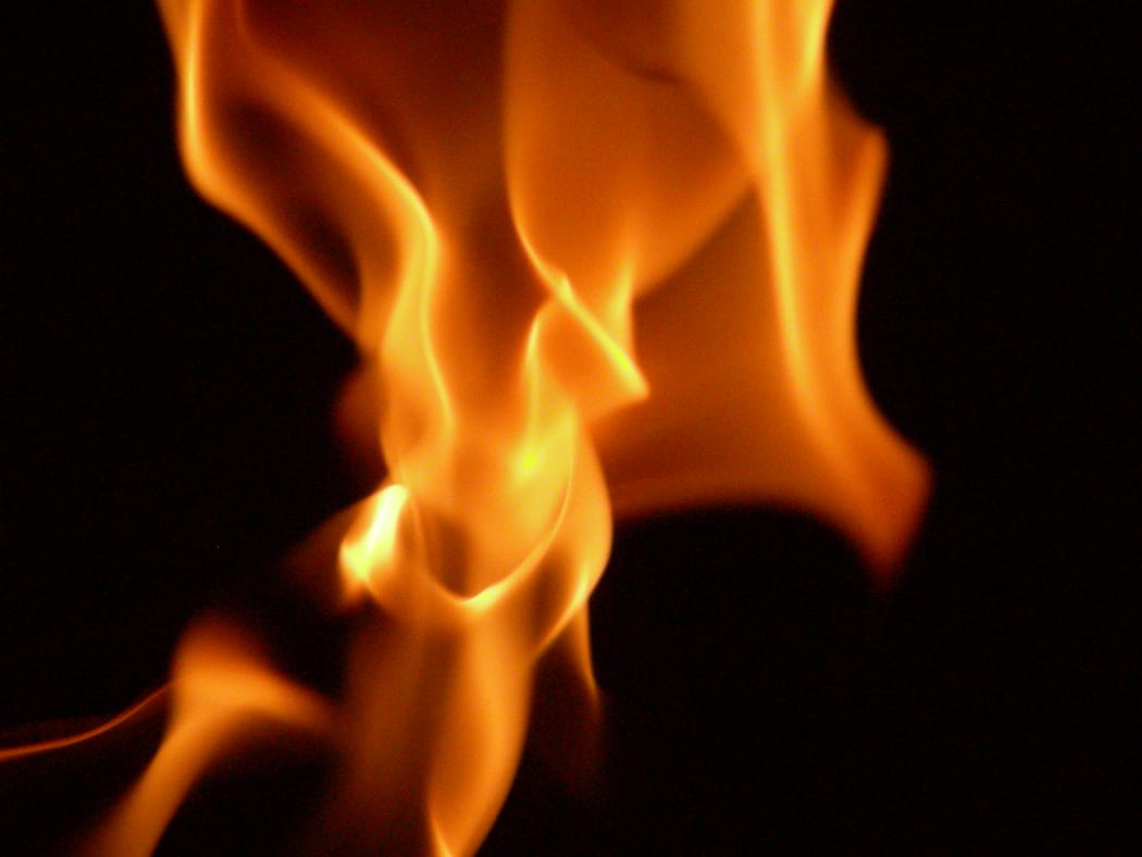 Dancing Flames of burning charcoal in the dark