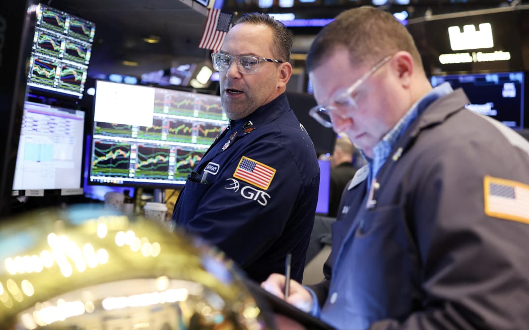 A trader works on the floor of the New York Stock Exchange (NYSE) at the opening bell in New York City, on April 2, 2025. (Photo by CHARLY TRIBALLEAU / AFP)