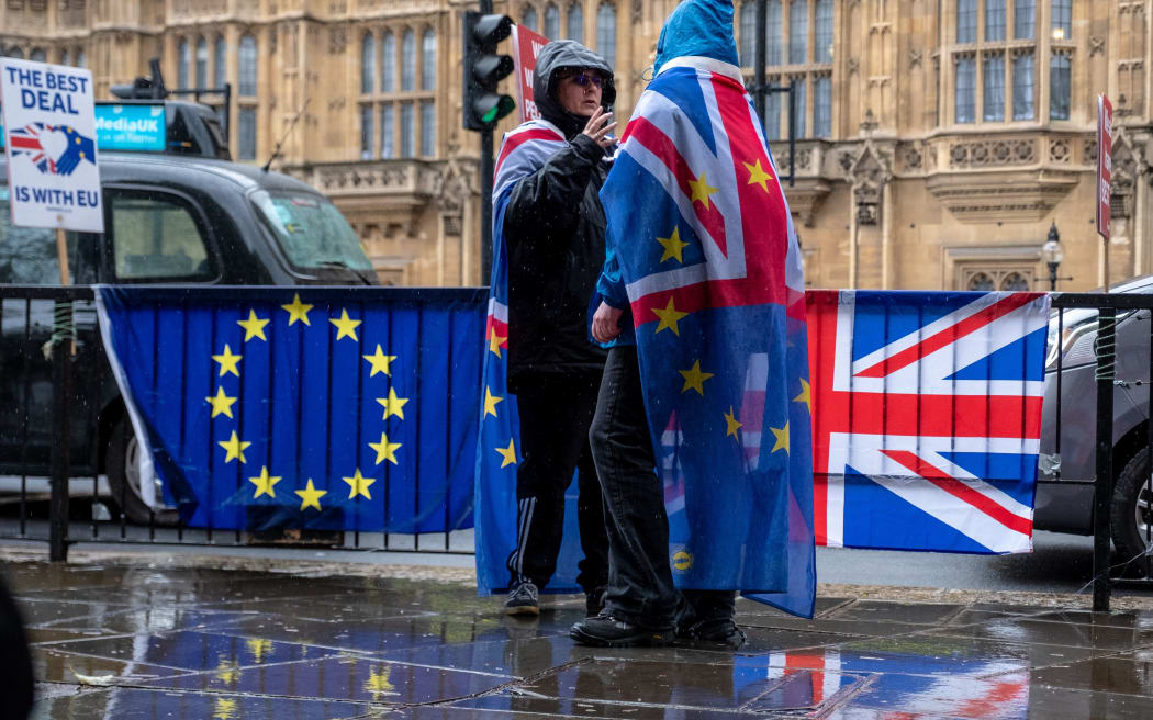 Anti-Brexit demonstrators protest outside Houses of Parliament in the rain, in London, United Kingdom, on April 2, 2019.