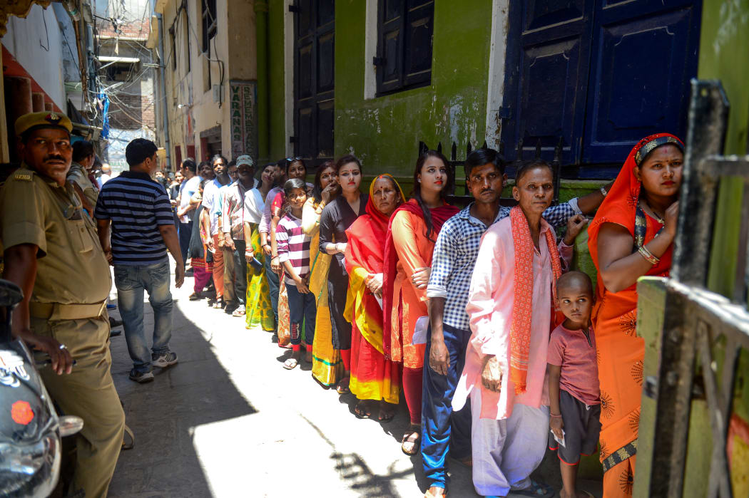 Indian voters queue at a polling station to cast their votes in Varanasi in Uttar Pradesh state on May 19 during the seventh and final phase of India's general election.