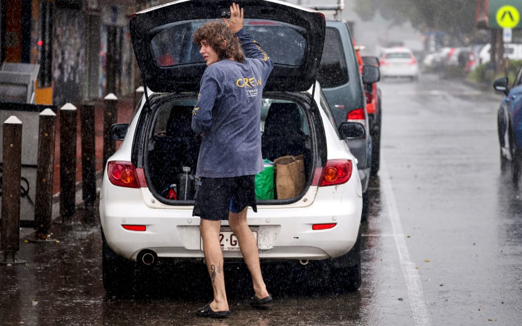 A resident packs a car with stock from a shop in the NSW town of Lismore, on 5 March, 2025, ahead of Tropical Cyclone Alfred.