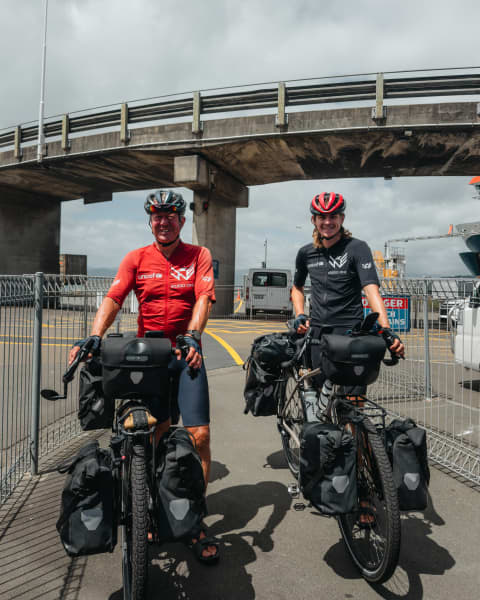Joshua, 23, and George Kohler, 57, are cycling around the world. They say NZ has had the most beautiful scenery, but the angriest drivers.