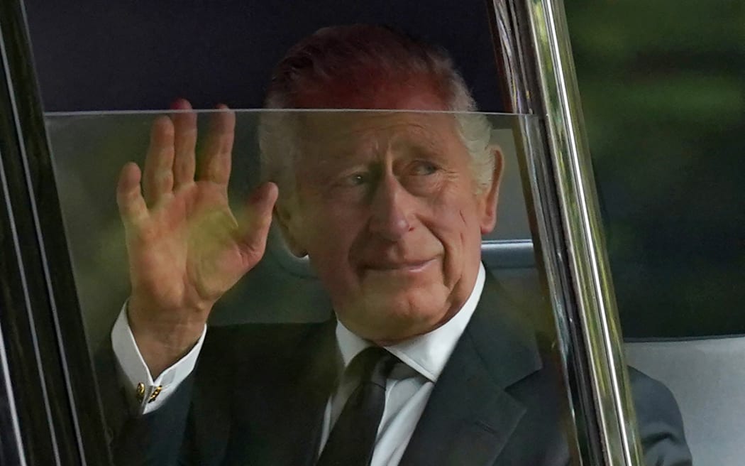 Britain's King Charles III waves to the crowds after leaving Clarence House in central London on September 14, 2022, ahead of the ceremonial procession of the coffin of Queen Elizabeth II, from Buckingham Palace to Westminster Hall. - As preparations build for next week's state funeral, the royal family on Wednesday will walk behind the queen's coffin in a procession through central London, after which thousands of members of the public are expected to come to pay their final respects at her lying in state. (Photo by Stefan Rousseau / POOL / AFP)