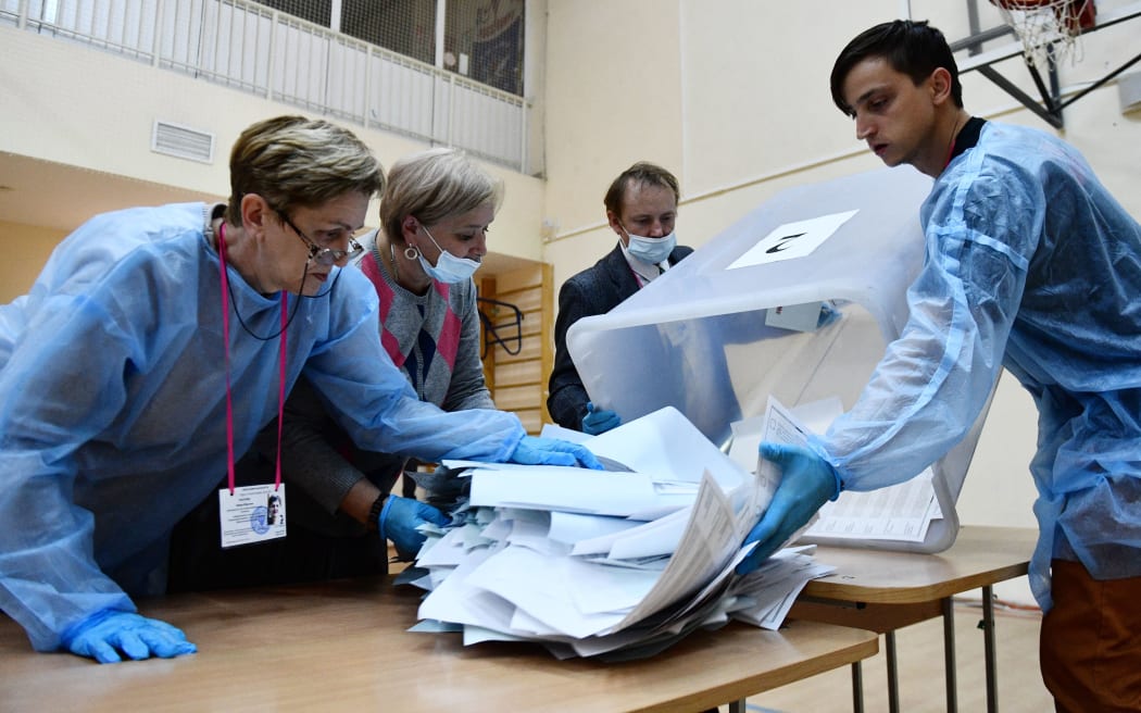 Local election commission members count ballots at a polling station after the three-day parliamentary and local elections, in Yekaterinburg, Russia. Voters elect members of the Russian State Duma and heads of nine Russian regions and 39 constituent regions.