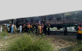 Pakistani rescuers shifting victims from a train after a fire erupted on board in southern Punjab province on 31 October, 2019.