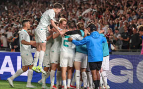 The All Whites celebrate their victory.