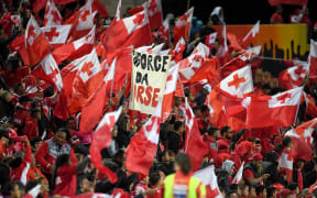 Tongan fans celebrate their team's win over Great Britain in Hamilton