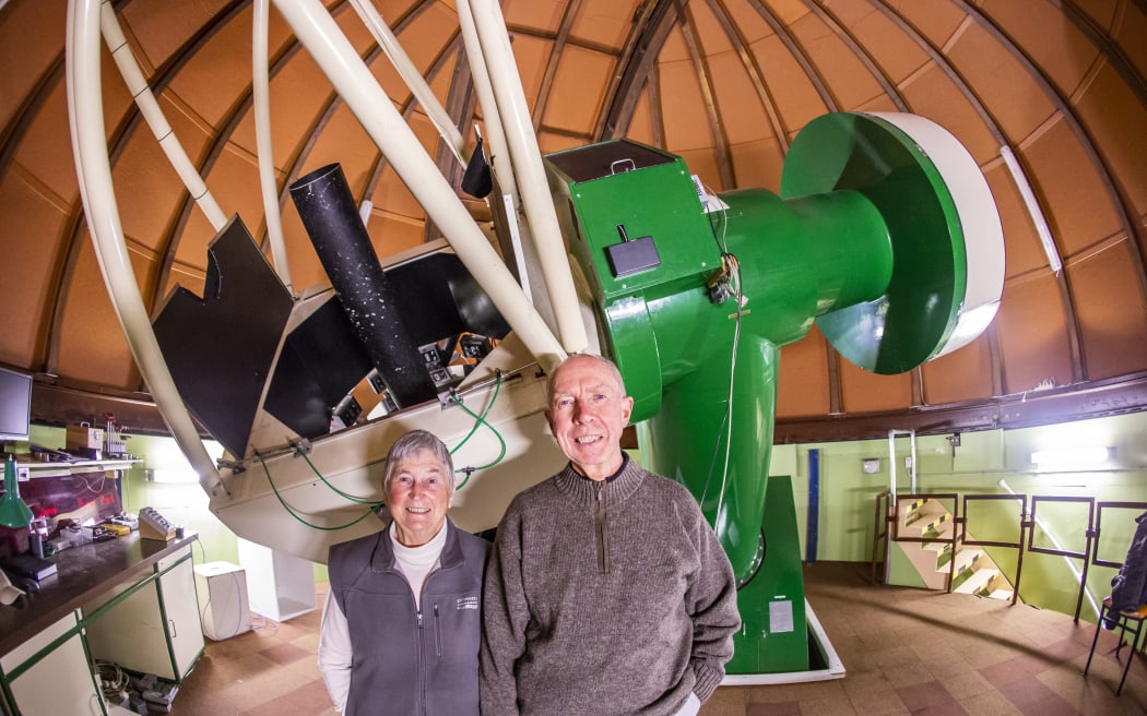 Kilmartin and Gilmore pictured with Mt John's 1-metre telescope in 2019.