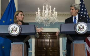 US Secretary of State John Kerry (R) listens while EU High Representative Federica Mogherini makes a statement to the press after a working lunch at the US Department of State in January 2015.