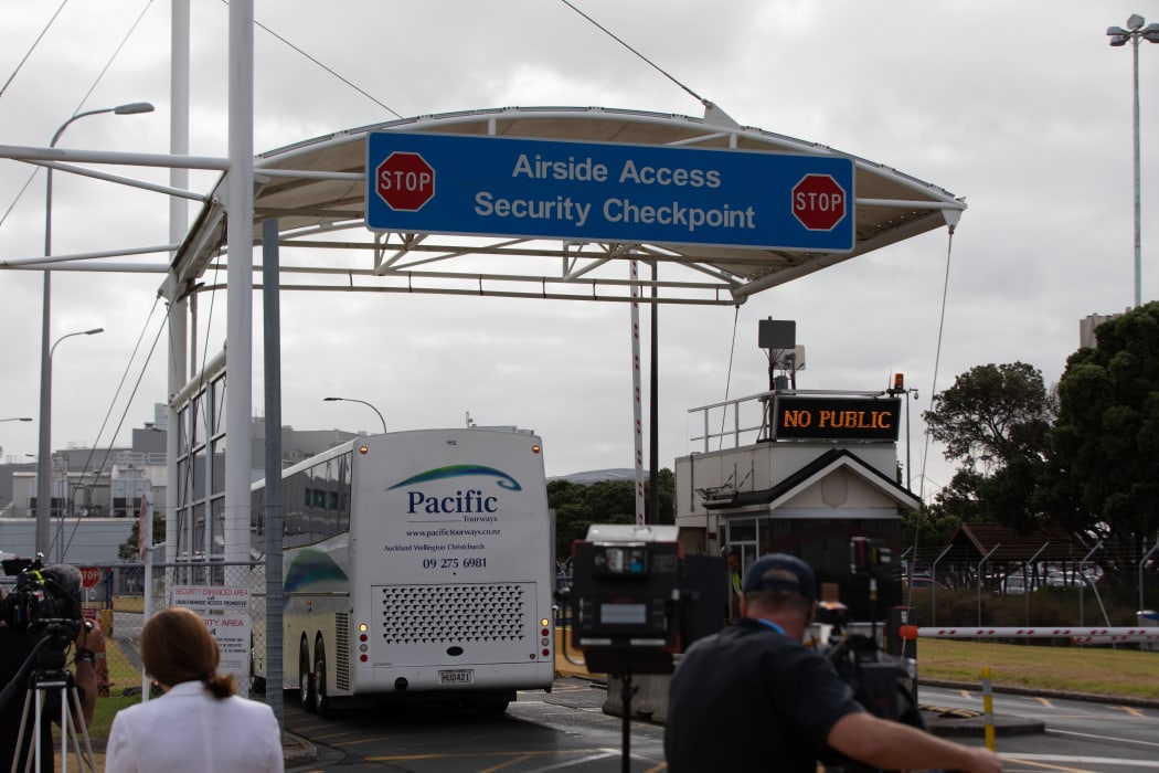 Buses arrive to collect passengers from the Air New Zealand flight chartered by the government to evacuate people from Wuhan during the coronavirus outbreak.