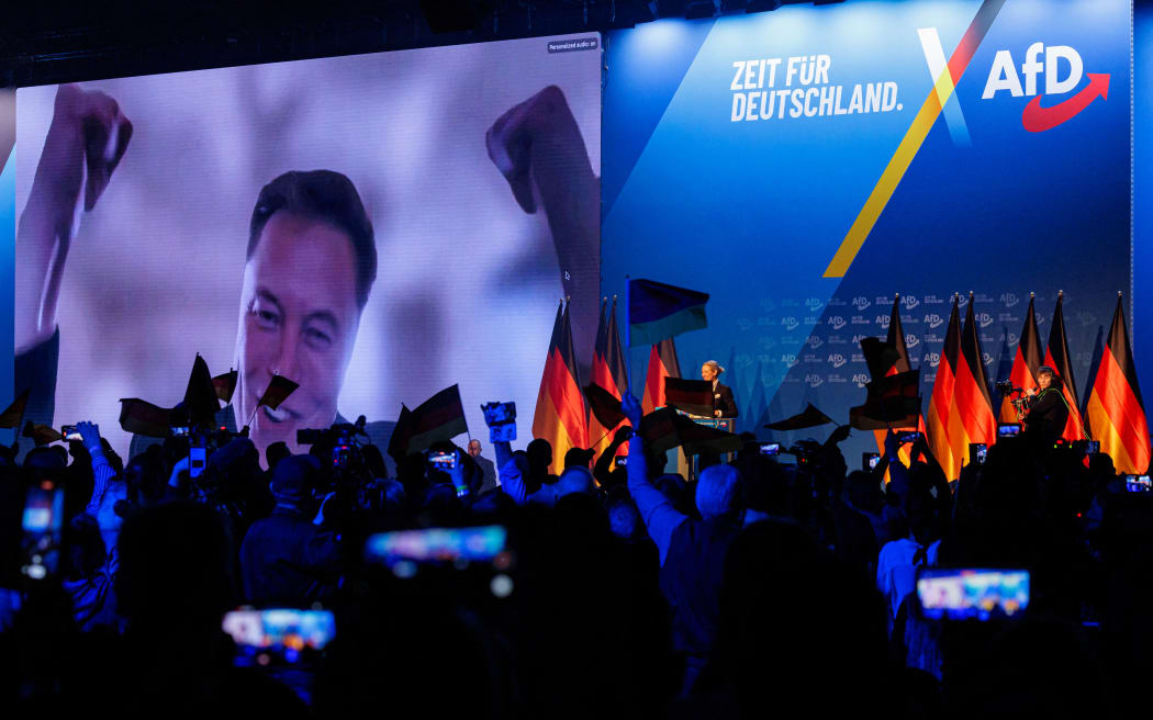 US tech billionaire and businessman Elon Musk is seen on a large screen as Alice Weidel, co-leader of Germany's far-right Alternative for Germany (AfD) party, addresses an election campaign rally in Halle, eastern Germany on 25 January, 2025.