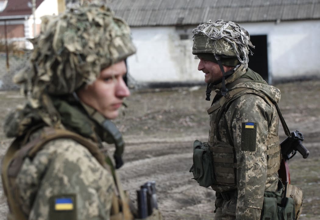 Ukrainian servicemen are seen at a position on the front line with Russia-backed separatists near the town of Schastia, near the eastern Ukraine city of Lugansk, on February 23, 2022.