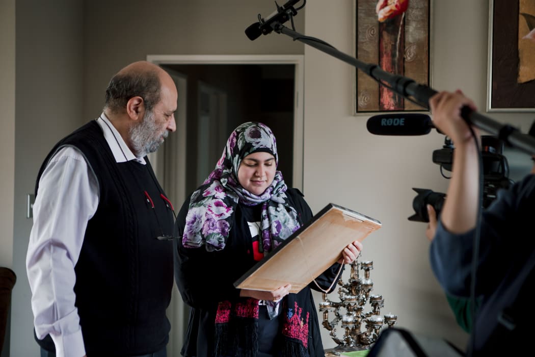 Mahmud and his daughter Shayma'a look at their family tree